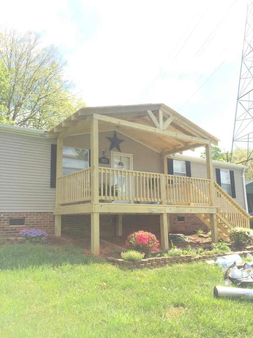 New gabled porch roof and deck railing added to a ranch home in Josephine
